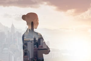 A Chinese woman looking at a city skyline.