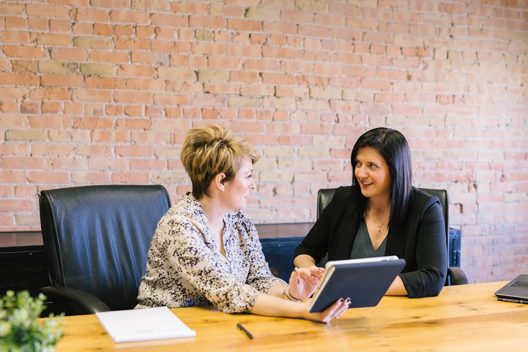 A friendly Schneider and Associates agent consulting with a small business owner in an office in Orlando, Florida. - insurance for business continuity